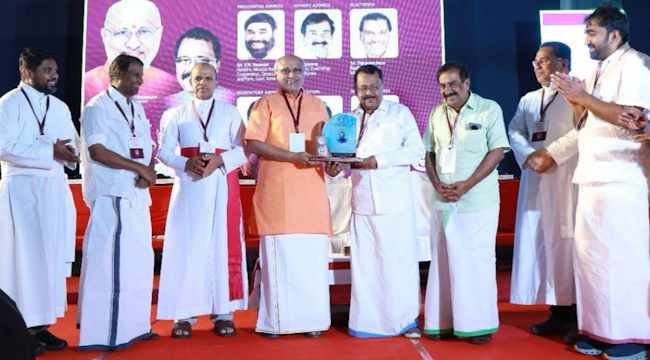 Receiving award from Vice President C. P. Radhakrishnan
